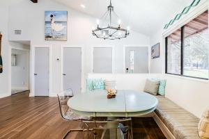 a dining room with a glass table and a couch at Lake LBJ Waterfront Family-Friendly Retreat in Granite Shoals