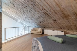 two beds in a room with a wooden ceiling at Bunker Loft Messe Essen Self Check-in in Essen