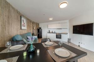 a kitchen and living room with a table and chairs at Bunker Loft Messe Essen Self Check-in in Essen