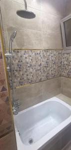 a bathroom with a bath tub with a faucet at aladdin hotel Egypt Badr in Cairo +48 photos