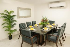 a dining room with a table and chairs at Sunset Suites Mazatlán at Lomas de Mazatlán in Mazatlán