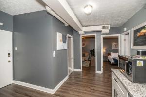 a living room with blue walls and wooden floors at Monmouth Loft 4 - Walk to Shops in Newport +41 photos