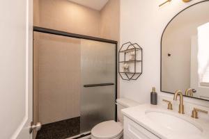 a bathroom with a shower with a toilet and a sink at Covington Charm 201 in Covington