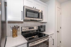a kitchen with a stove and a microwave at Covington Charm 101 in Covington