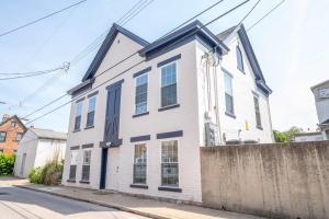 a white house with blue trim on a street at Covington Charm 101 in Covington