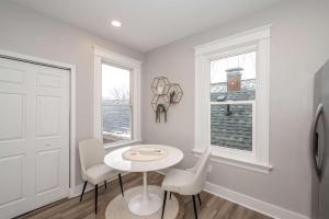 a white room with a table and chairs and a window at LUXE Spot 2 in Covington