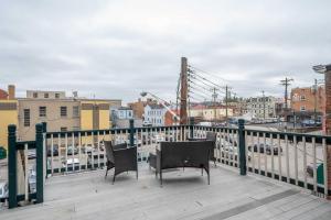 a balcony with two chairs and a view of a city at Heart of Madison 2 in Covington
