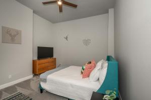 a bedroom with a bed and a flat screen tv at Heart of Madison 2 in Covington