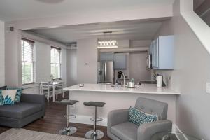 a kitchen and living room with two chairs and a counter at Heart of Mainstrasse 4 in Covington +26 photos
