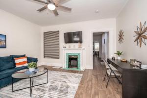 a living room with a blue couch and a fireplace at Historic Ludlow Apt A in Ludlow +27 photos