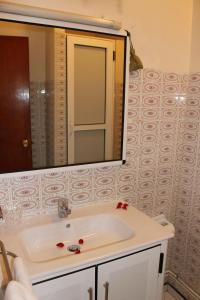 a bathroom with a sink and a mirror at Hotel Sindibad in Agadir