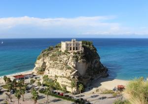 a castle on top of a rock in the ocean at Tropea Belle Époque in Tropea