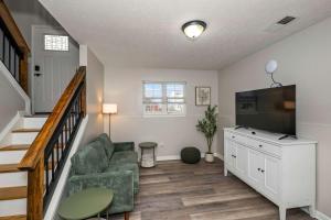 a living room with a couch and a flat screen tv at The Restful Ark in Crittenden