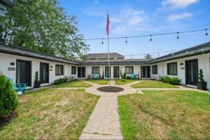a house with an american flag in the yard at Chic City Retreat 99 For 2 in Columbus