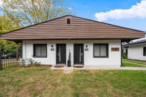 a white house with a brown roof at Chic City Retreat 99 For 2 in Columbus +21 photos