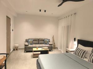 a living room with a bed and a couch at Down Town Skiathos in Skiathos Town +3 photos
