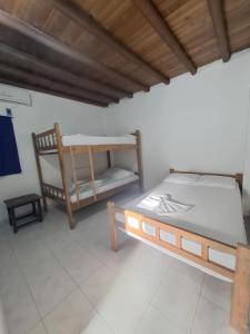 a room with a bed and a chair in it at Borealis Apartahotel Tolú in Tolú