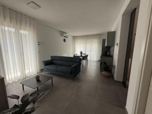 a living room with a couch and a table at Dimora House and Relax in San Benedetto del Tronto