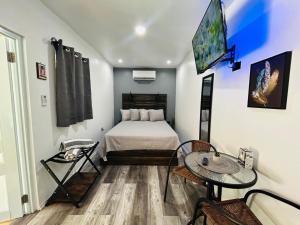 a small room with a bed and a table at Salty Wagon Studio - 4 min from Almendros Beach in Rincon