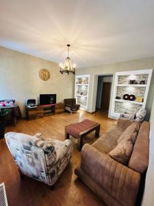 a living room with a couch and a table at Hill House in Stepantsminda