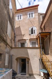 a building with a staircase in front of it at Good vibes house in Cres