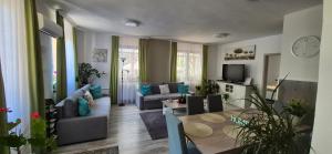 a living room with a couch and a table at Nagcsaládos Rózsa Apartman in Balatonlelle