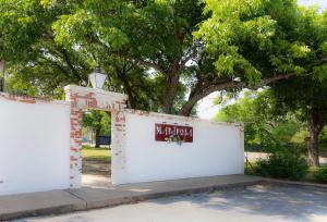 a white wall with a sign on it at Mariposa Monarch - Walk to River in Kerrville
