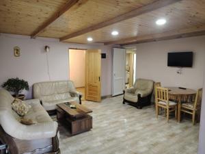 a living room with a couch and a table at Relax in the mountains - kazbegi in Arsha