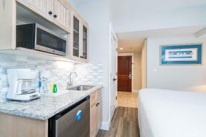 a kitchen with a sink and a counter top at Seashell Shuffle at Sandestin Pilot House in Destin