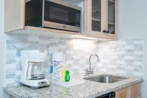 a kitchen counter with a blender and a sink at Seashell Shuffle at Sandestin Pilot House in Destin