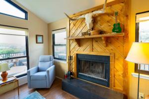 a living room with a fireplace and a blue chair at Stargazers Delight - Sleeps 12 in Johnson City