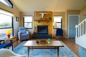 a living room with a table and a fireplace at Stargazers Delight - Sleeps 12 in Johnson City +40 photos