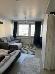 a living room with a couch and a living room with a window at Apartment Kopin3 in Kokkola