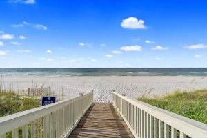 a boardwalk to the beach with the ocean in the background at Beach Access with Elevator & FREE Activities in Gulf Shores