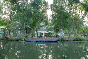 a small boat in the water with a playground at Aqualillies Water Front Heritage Homestay in Kumarakom