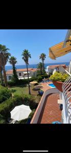 a view of a resort with a pool and an umbrella at Sole Mare da Tina in Cittadella del Capo