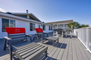 a deck with benches and tables on a house at Harbor Seahorse - Outdoor Deck & Boat Dock in Destin