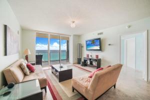 a living room with a view of the ocean at Balcony on the Ocean - Picture Perfect in Sunny Isles Beach