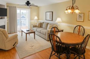 a living room with a couch and a table at Acadia Village Resort in Ellsworth