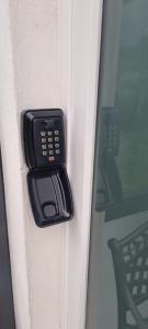 a black door handle on a door with a window at Ferienwohnung Odersee in Hattorf