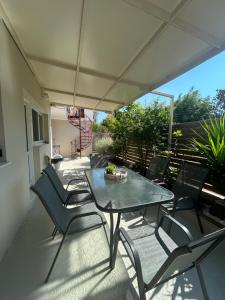 a patio with a table and chairs on a balcony at polyxeni house in Lygia
