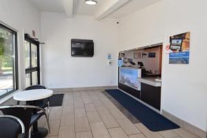 a waiting room with a counter and a table and chairs at Motel 6-Hamburg, NY in Hamburg