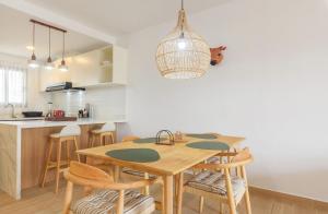 a kitchen and dining room with a wooden table and chairs at Sausalito | Pool View Retreat in Punta Cana