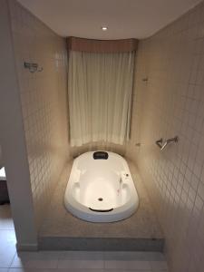 a toilet in a bathroom with a face drawn on it at Apartamento Suíte Flat Hot Springs Hotel em Caldas Novas com parque aquático in Caldas Novas