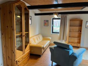a living room with a couch and a chair at Dänishe Wohnung auf Fehmarn in Fehmarn