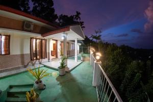 a villa with a pool at night at Emerald Hill Bungalow in Kandy