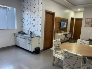 a kitchen with a table and chairs and a counter at VivaVida Imperial 103 in Sinop