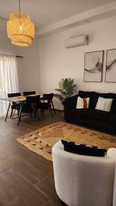 a living room with a couch and a table at Modern boho Apt in Punta Cana in Punta Cana