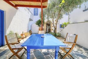 a blue table and chairs on a patio at Villa Archontissa in Spetses