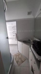 a small bathroom with a sink and a tub at Cozy Garden Villa in Ventspils
